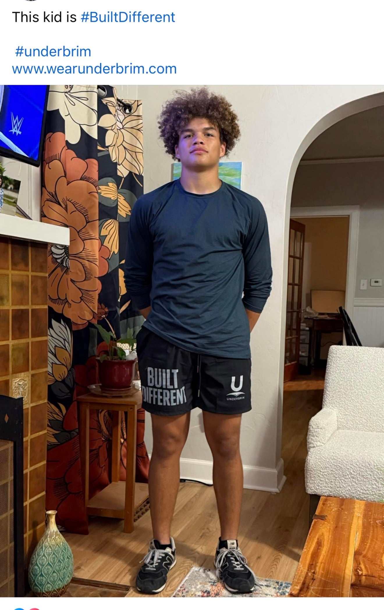 Male model wearing Underbrim Built Different performances shorts, black with BUILT DIFFERENT text and Underbrim logo.